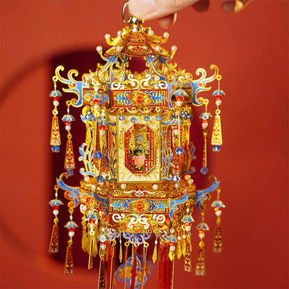 Hand holding the top of the palace lantern to show its detailed metal decoration